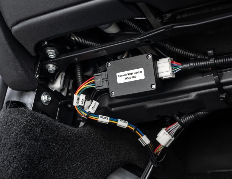 Clean remote start installation with wiring and control module under the dash at Premiere Service & Performance
